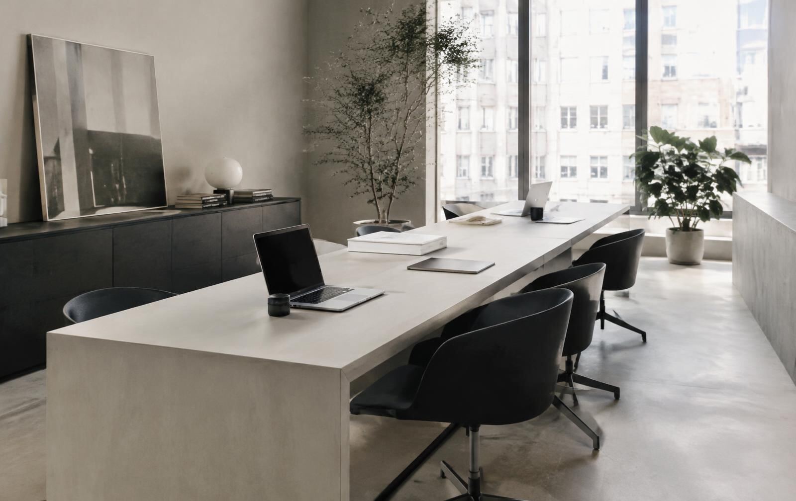 Quiet modern office with laptops on a long shared table